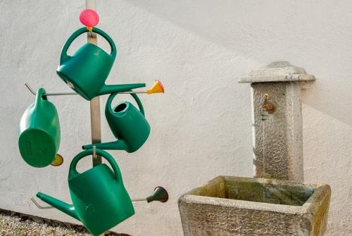 Na sliki je fontana in zalivalke na pokopališču.